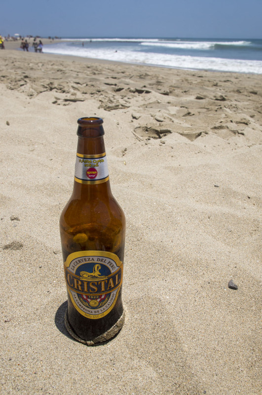 enjoying a Cristal beer on the beach in Mancora Peru