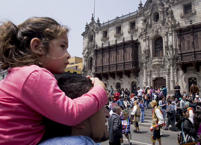 little girl watching parade in Lima