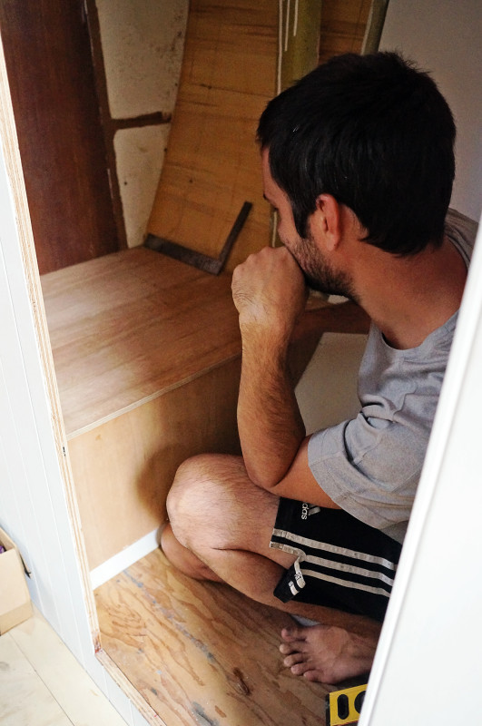 Matt building plywood box for toilet