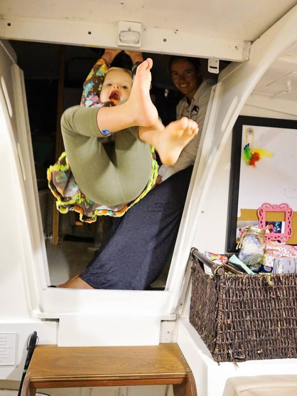 Ani swinging from companionway